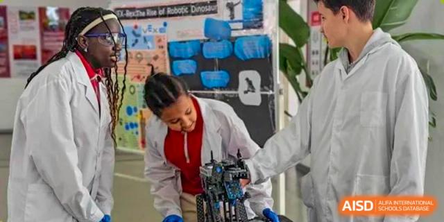 A student from EtonHouse International School Nanjing in a lab coat, working on a project.