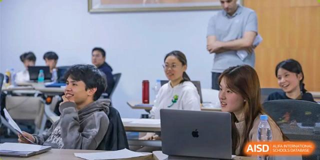 A teacher from EtonHouse International School Nanjing teaching a class with a laptop.