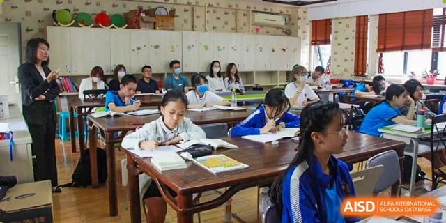 Students from EtonHouse International School Nanjing sitting at desks and studying.