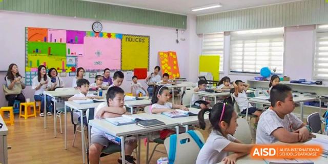 Students from EtonHouse International School Nanjing in a classroom, with a teacher at the front.
