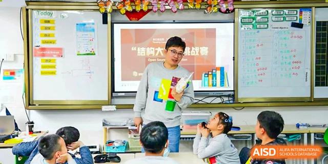 A teacher from Shanghai Concord Bilingual School gives a presentation to a class of young students.