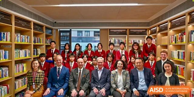 A large group of students and adults from Shanghai Concord Bilingual School are seated and smiling for a photo.