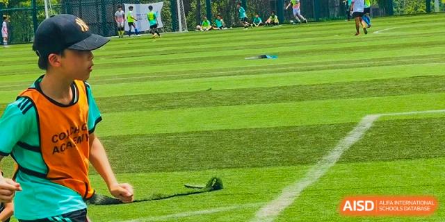 A long shot of a grassy sports field at Shanghai Concord Bilingual School.