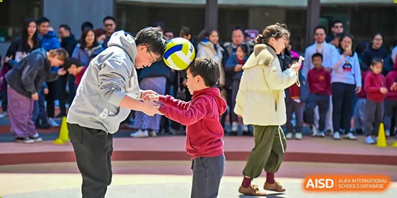 A student from Shanghai Concord Bilingual School receives a volleyball during a game.