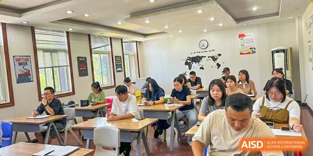 Students working on a small group activity in a bright, collaborative classroom at Wuxi Guanghua School.