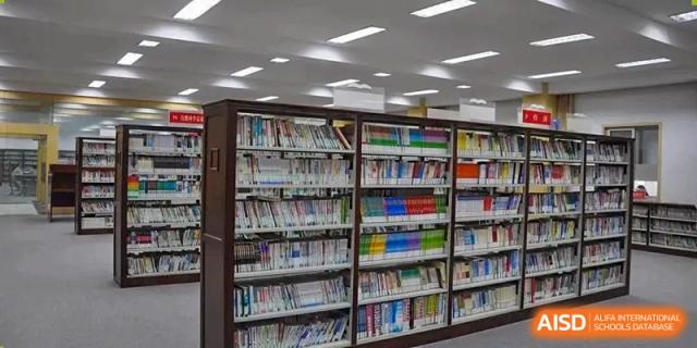 A view of the organized library shelves filled with books at Wuxi Guanghua School.