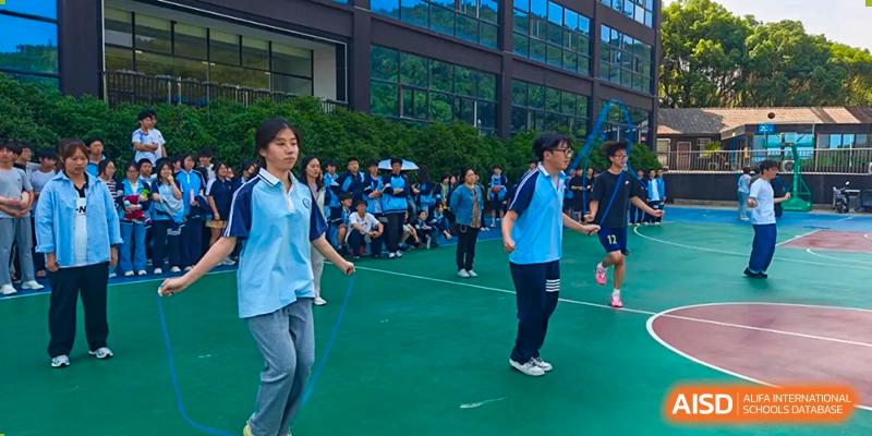 Students skipping rope and exercising outdoors during a physical activity session at Wuxi Guanghua School.