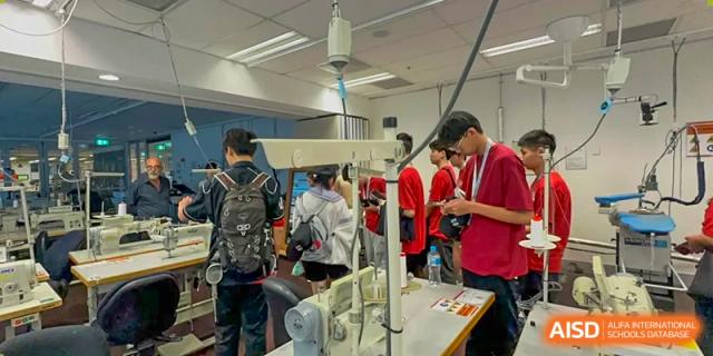 Students collaborating on a project or using specialized equipment in a workshop or makerspace at Wuxi Guanghua School.