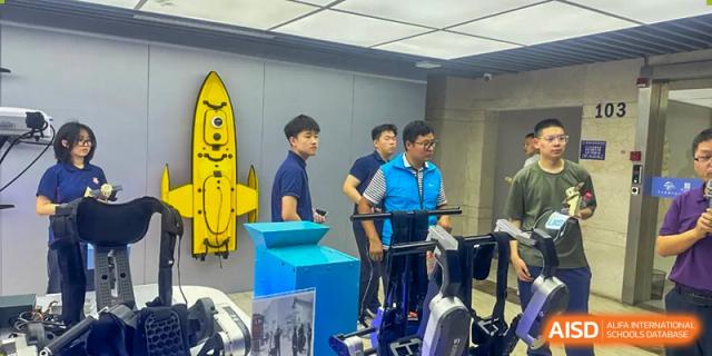 Students from Beijing Lize International Academy pose with a rocket model in a room with a blue background.