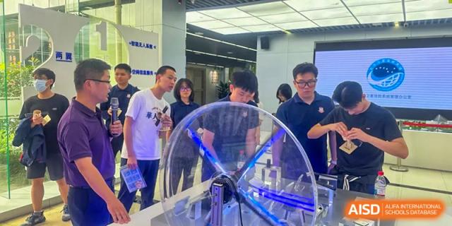 Students from Beijing Lize International Academy interact with a spinning machine.