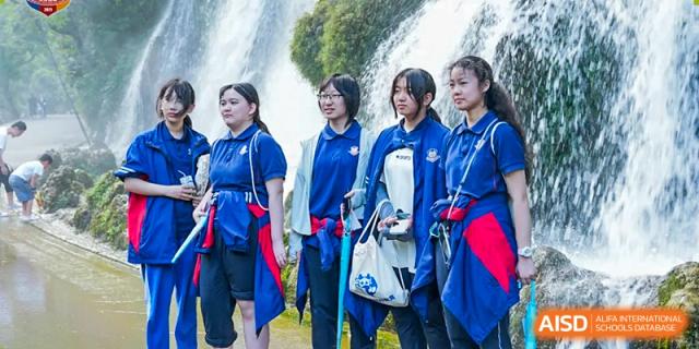 A group of students from Beijing Lize International Academy smiles while looking at something off-camera.