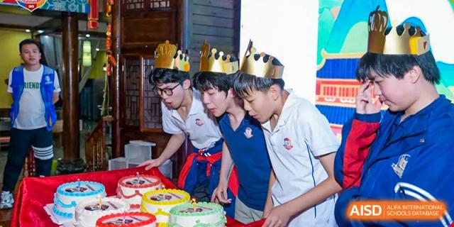 Students from Beijing Lize International Academy wear crowns and celebrate.