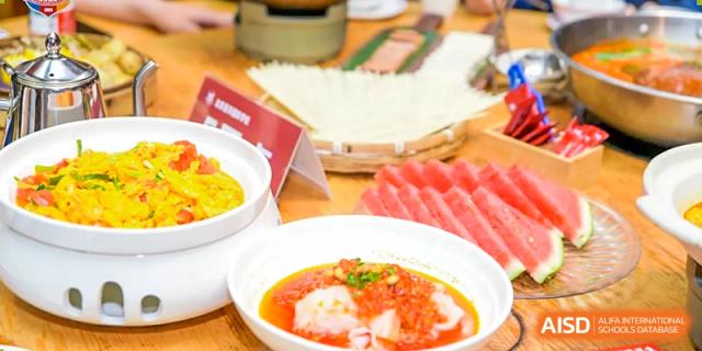 A table filled with hot pot food for students and teachers of Beijing Lize International Academy.