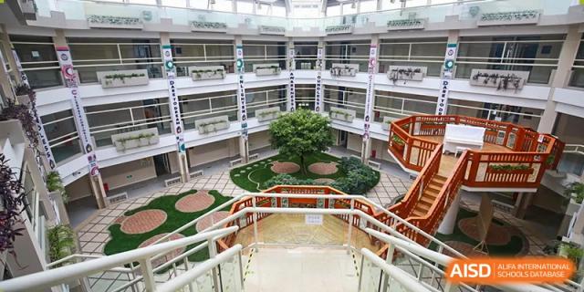A view of a school building with an open-air courtyard in the center at Beijing Mingcheng Academy.