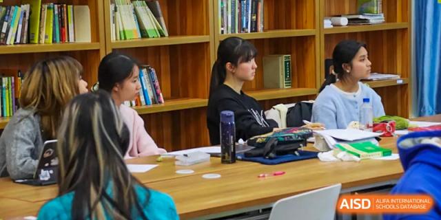 Students working at desks in a classroom at Beijing Mingcheng Academy.