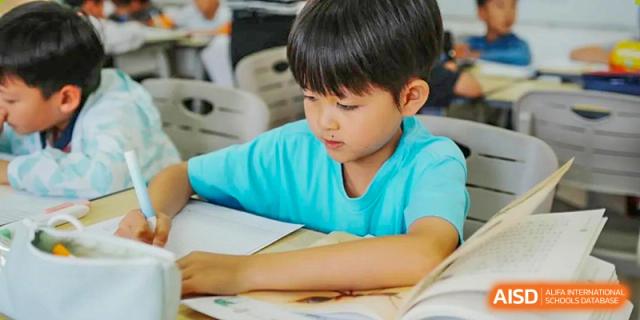 A young student from Kunming Concord College of Sino-Canada (CCSC) is focused on their work in class.