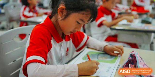 A student from Kunming Concord College of Sino-Canada (CCSC) draws or writes on a piece of paper.