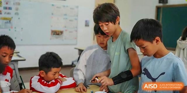 A teacher from Kunming Concord College of Sino-Canada (CCSC) helps a male student with his work.