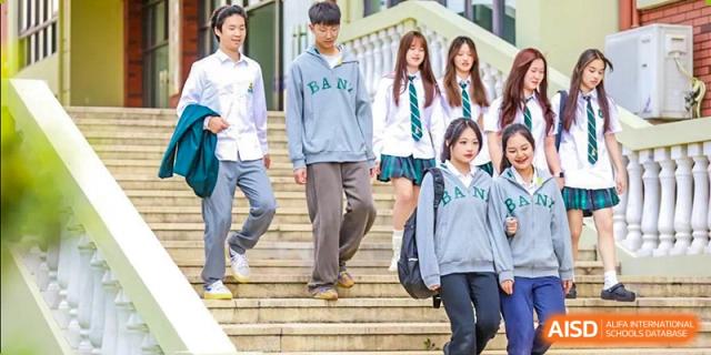 Students from Shanghai International High School of BANZ walking down a set of stairs on campus.
