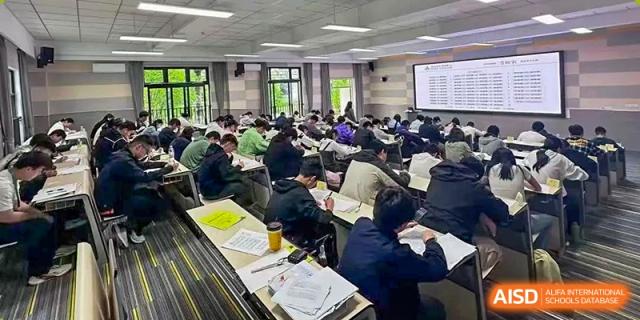 Students from Shanghai International High School of BANZ in a classroom, taking an exam or working quietly.