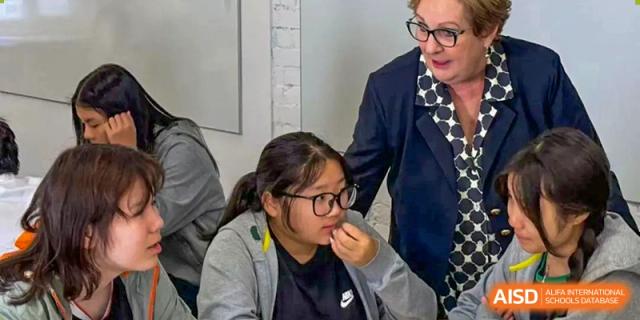 An instructor helps a student at Shanghai International High School of BANZ with her work.