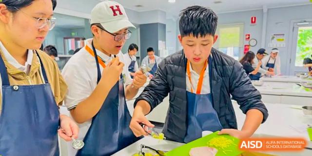 Two students from Shanghai International High School of BANZ participating in a cooking activity.