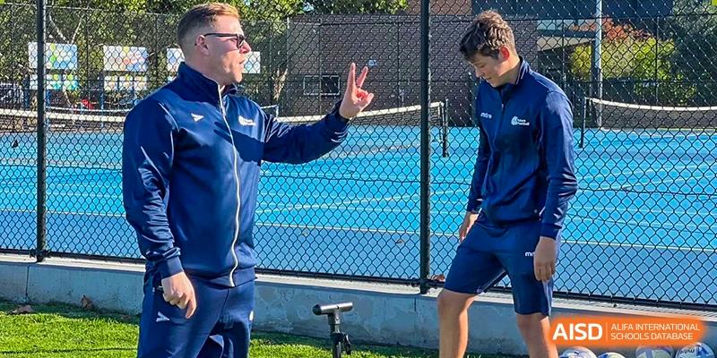 A student from Shanghai International High School of BANZ on a tennis court with a coach.