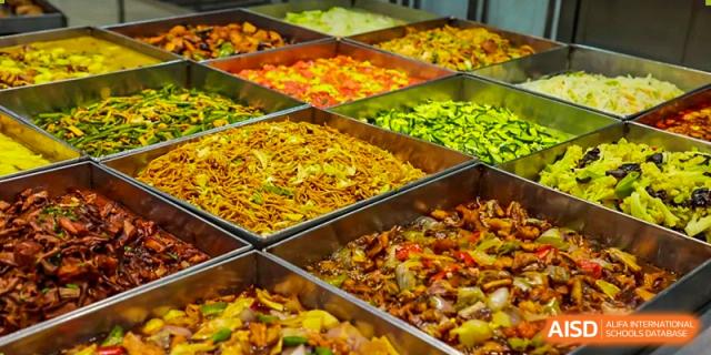 A variety of colorful dishes displayed in a cafeteria at Shanghai International High School of BANZ.