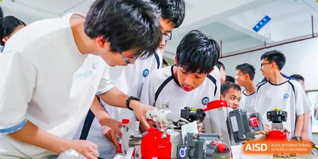 A group of male students from The Affiliated School of JNU for Hong Kong & Macau Students (ASJ Dongguan) are working together on a science experiment.