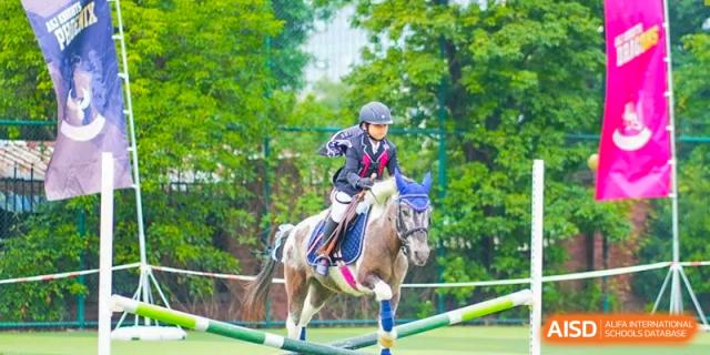 A student from The Affiliated School of JNU for Hong Kong & Macau Students (ASJ Dongguan) is riding a small horse.