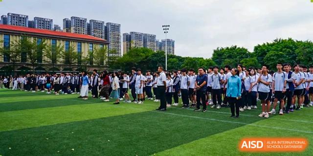 A group of students from The Affiliated School of JNU for Hong Kong & Macau Students (ASJ Dongguan) is participating in an outdoor sports event.