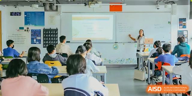 Students are listening to a teacher in a classroom at Vanke Meisha Academy.