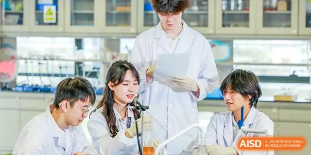 Two young students are working together in a science lab at Vanke Meisha Academy.