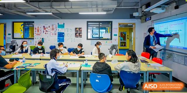 A group of students is seated in a classroom with desks and chairs at Vanke Meisha Academy.