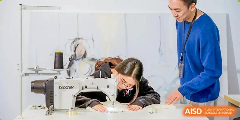 A female student uses a sewing machine at Vanke Meisha Academy.