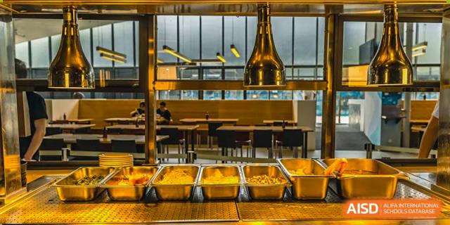A close-up shot of a food counter with several metal serving trays at Vanke Meisha Academy.