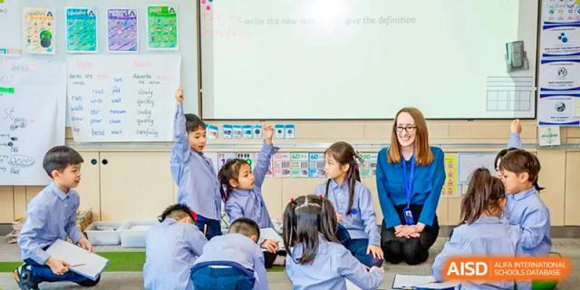 Students raising their hands in a classroom at Yew Chung International School of Chongqing