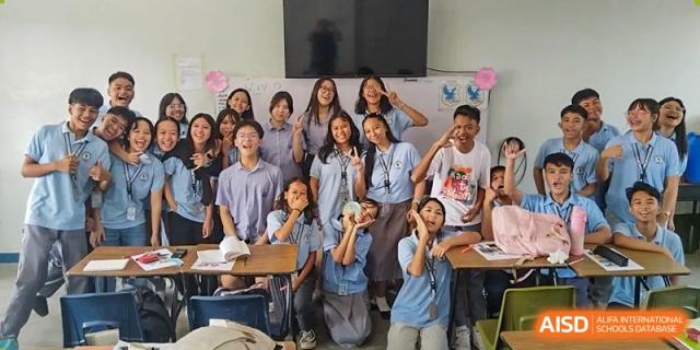 A large group of students and a teacher posing for a photo at Yew Chung International School of Chongqing
