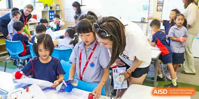 A teacher and a young student looking at a paper together at Yew Chung International School of Chongqing