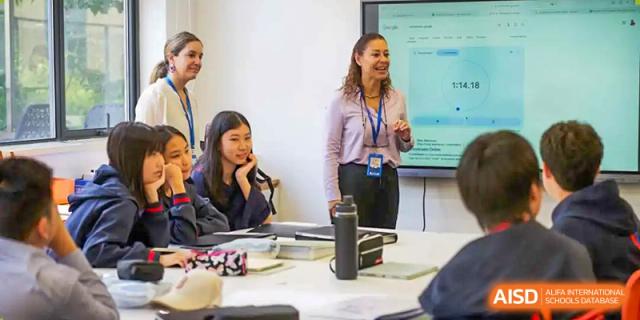 A teacher interacting with a student in a classroom at Yew Chung International School of Chongqing