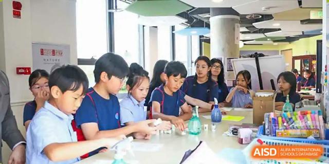 Students working on a science experiment with beakers and other lab equipment at Yew Chung International School of Chongqing