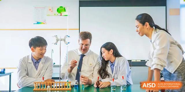 A teacher and a student conducting a science experiment in a lab at Yew Chung International School of Chongqing