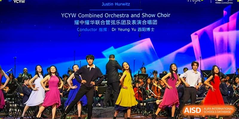 An orchestra and a show choir performing on a stage at Yew Chung International School of Chongqing