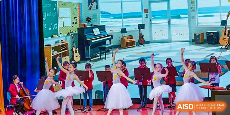 Young students in ballet and musical attire performing on a stage at Yew Chung International School of Chongqing