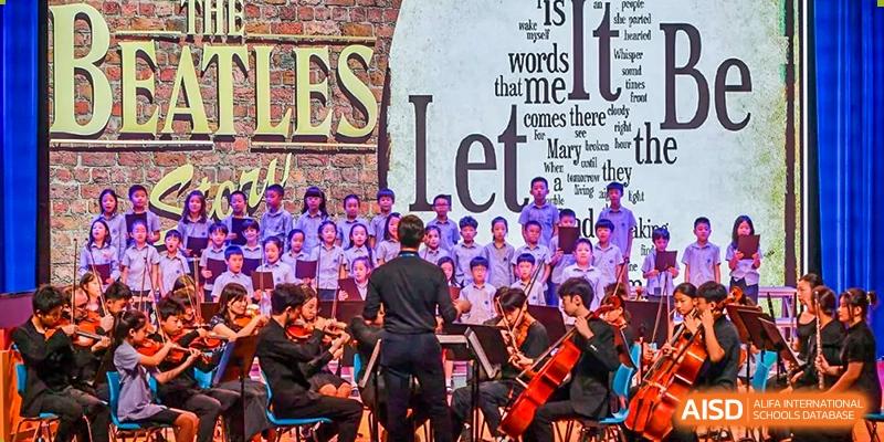 An orchestra performing on a stage at Yew Chung International School of Chongqing