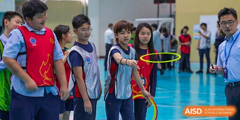 Students playing with hula hoops during a sports activity at Yew Chung International School of Chongqing
