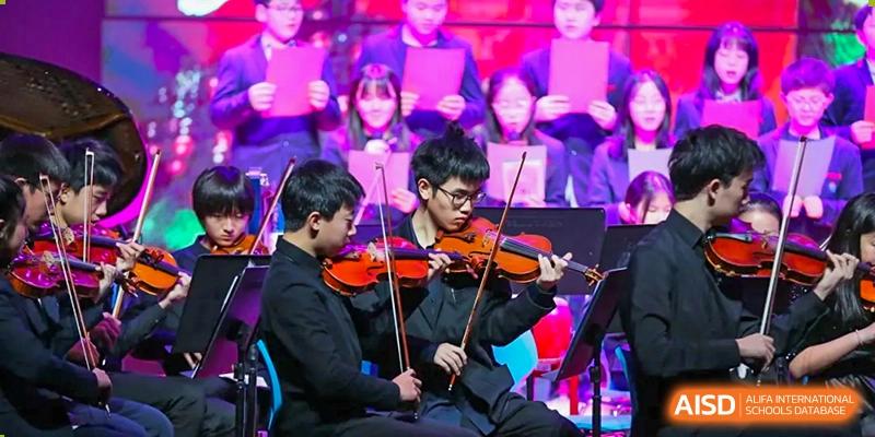 A male student playing the violin during a performance at Yew Chung International School of Chongqing