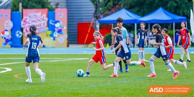 Students playing soccer on an outdoor field at Yew Chung International School of Chongqing