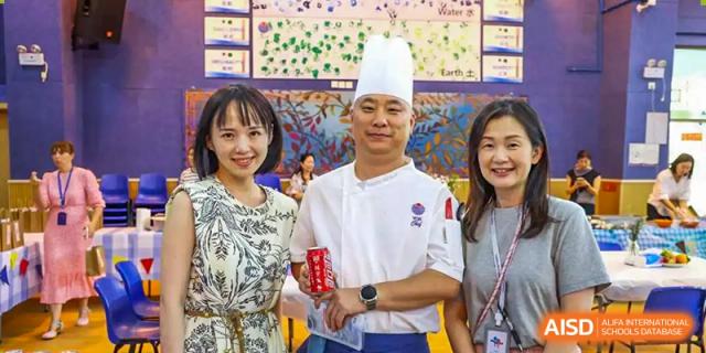 A chef in a white hat posing for a photo with a student at Yew Chung International School of Chongqing