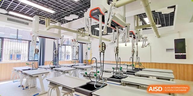 Modern laboratory equipment, including sinks and suspended fixtures, showcasing facilities at Yiwu International Academy.